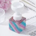 Detail view of a luxury rhinestone soap dispenser with a flower-shaped foaming pump head - Royal Blue