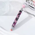 Close-up detail of luxury leopard pattern rhinestone nail dotting pen on fashion book backdrop - Pink Leopard