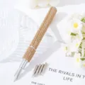 Close-up detail view of a luxury rhinestone nail art pen with 5 interchangeable metal nibs. - Champagne Gold