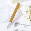 Detailed view of luxury gold rhinestone nail art pen with five replaceable metal tips. - Yellow