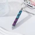 Macro detail of dual-ended nail art dotting pen decorated with purple and blue rhinestones - Mermaid Skirt