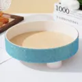 Detailed close-up of a circular tray featuring a light blue rhinestone studded border. - Lake Blue