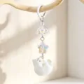 Detailed view of a cute white flocked kitten keychain featuring an iridescent star pendant. - Spring Buckle (Style 1)