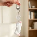 Detail shot of a white flocked cat keychain charm with a clear faceted crystal bead - Gate Buckle (Style 3)
