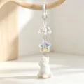 Detail of a cute white flocked cat keychain with an iridescent star and clear bell charm - Spring Buckle (Style 3)