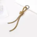Detailed view of champagne gold rhinestone cord charm for bags and phones - Champagne