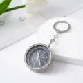 Close-up of a stylish rhinestone-studded mini compass keychain for outdoor navigation - White