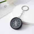 Detailed view of rhinestone-studded aluminum compass keychain for outdoor navigation - Black