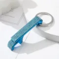 Macro detail of blue rhinestone-encrusted aluminum bottle opener keychain accessory - Lake Blue