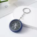 Close-up of mini outdoor compass keychain with blue rhinestone rim and aluminum dial - Blue