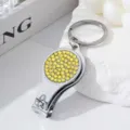 Multifunctional silver nail clipper keychain featuring sparkling yellow rhinestones decoration - Yellow