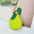 Close-up of a pear-shaped PU leather pouch showing lychee grain texture and gold metal clip - Pear Style