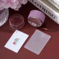 Close-up detail of a pink rhinestone nail art stamper set with a floral etching plate - Light Purple