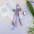Detail of cotton rope bow keychain with a silver heart charm on white aesthetic background - Purple Rainbow Bow Silver Heart (1) / Purple Rainbow Gradient