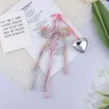 Close-up of a pastel braided rope bow keychain with a glossy silver heart charm - Pink Rainbow Bow Silver Heart (4) / Pastel Gradient