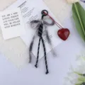 Detailed view of woven cotton rope bow keychain with a dark red resin heart pendant charm - Grey Black Bow Red Heart (6) / Black and Gray