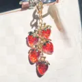 Translucent red resin strawberry keychain charm with five pendants on gold chain - Transparent Red
