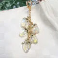 Aurora iridescent resin strawberry charm keychain accessory with golden heart clasp - Clear White