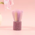 Detailed view of a pink rhinestone makeup brush with soft rainbow-colored bristles - Pink