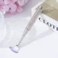 Close-up detail of a rhinestone-studded handle on a professional nail art fan brush. - AB White
