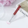 Close-up view of red rhinestone handle nail fan brush with pink gradient bristles - Red