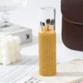Detailed view of a luxury gold rhinestone makeup brush container with 5 soft pieces. - Yellow