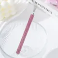 Close-up of a pink rhinestone nail art tool designed for spider gel pulling effects - Pink