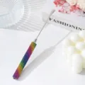 Close-up of rainbow rhinestone handle on stainless steel nail art mixing spatula tool - Colorful