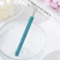 Macro detail of blue rhinestone handle nail art drawing tool with fan-shaped metal tip - Lake Blue