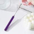 Close-up of professional stainless steel nail art mixing spatula with purple rhinestone handle - Deep purple