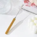 Macro detail of stainless steel nail spatula with yellow rhinestone handle. - Yellow