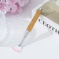 Close-up of a rhinestone-studded nail art fan brush for professional manicure - Yellow