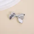 Elegant silver metallic 3D bow-shaped charm with a glossy chrome finish for DIY jewelry - 3.2x2.3cm