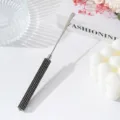 Macro detail of professional stainless steel nail art mixing spatula with black rhinestone handle - Black
