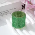 Macro view of detailed green rhinestone-encrusted nail art crystal dappen dish - Transparent Cup / Green
