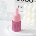 Detailed macro view of a pink rhinestone-covered essential oil dropper bottle for travel - 10ml / Pink