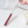 Detailed view of stainless steel nail art spatula with luxury red rhinestone handle - Red