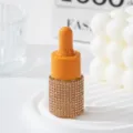 Close-up of a luxury orange essential oil dropper bottle with rhinestone base decoration - 10ml / Champagne Gold