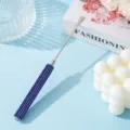 Close-up of stainless steel nail art spatula with luxurious blue rhinestone handle - Sapphire Blue
