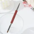 Detailed view of a double-ended nail art brush featuring a luxury red rhinestone handle - Red