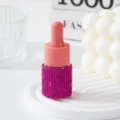 Macro detail of a sparkling pink rhinestone-studded essential oil dropper bottle - 10ml / Rose Red