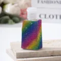 Macro detail of rainbow rhinestone covered travel perfume spray bottle - 30ml / Rainbow