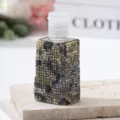 Detail of luxury rhinestone-encrusted travel spray bottle with cheetah pattern - 30ml / Leopard Print