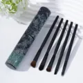 Detailed view of 5-piece makeup brush set with shimmering rhinestone storage tube - Python Green