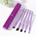 Detail view of purple rhinestone makeup brush set with sparkly cylindrical storage case. - Rose Red