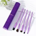 Detail of purple rhinestone makeup brush tube with five professional soft brushes. - Deep purple
