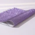 Detail macro view of purple self-adhesive rhinestone sticker sheet with backing. - Dreamy Purple