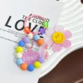 Farbenfroher Schlüsselanhänger mit Glitzer-Sonnenblume, Smiley und Herzanhänger - Rosa