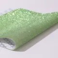 Close-up of light green rhinestone adhesive sheet showing glitter texture and backing - Light Green