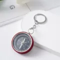 Detailed view of a mini rhinestone-studded aluminum alloy compass keychain - Red